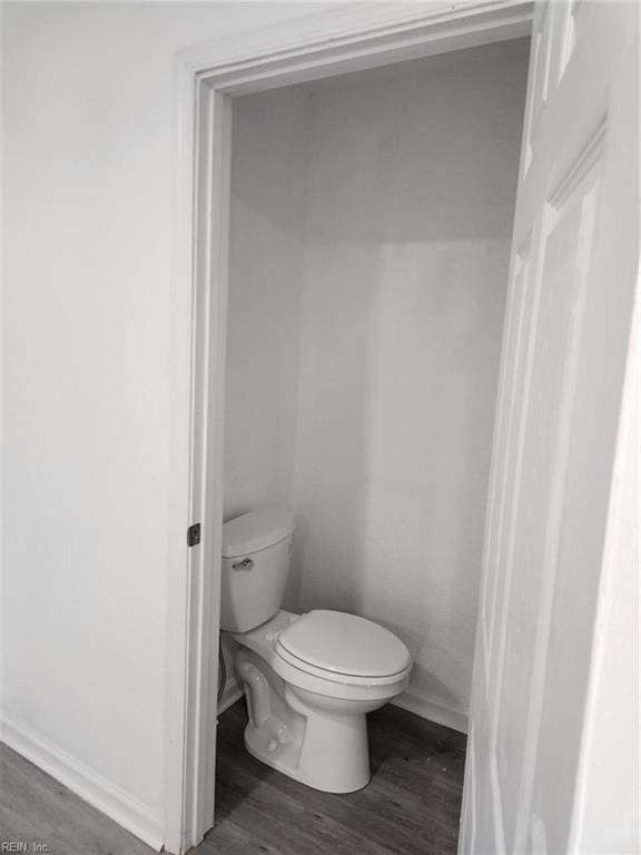 bathroom featuring hardwood / wood-style flooring and toilet