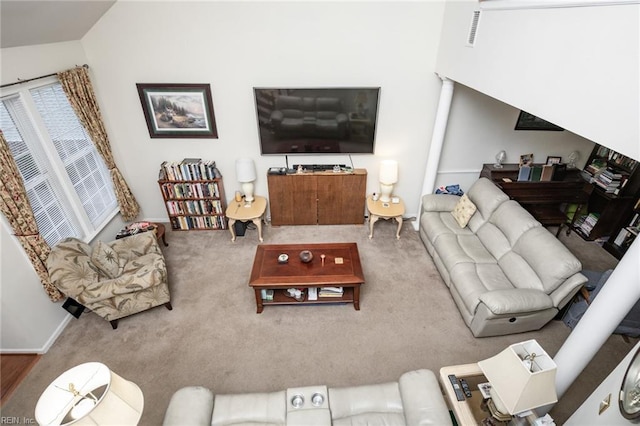 carpeted living room featuring decorative columns