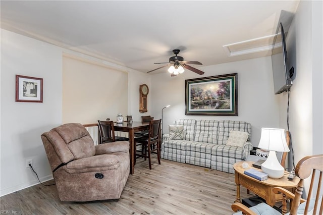 living room with ceiling fan and light hardwood / wood-style floors