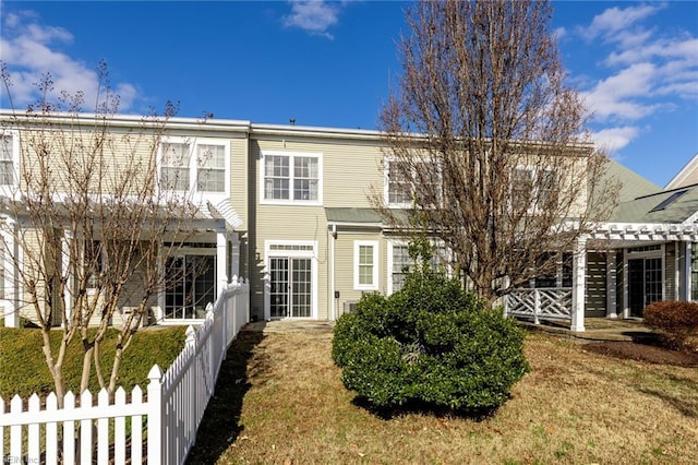 back of house with a pergola and a yard