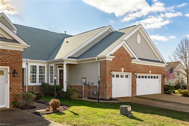 view of front of home with a front yard and a garage