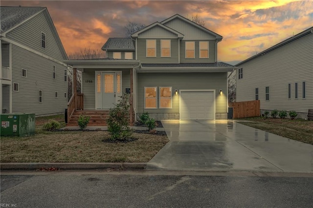 view of front of property with a lawn, cooling unit, and a garage