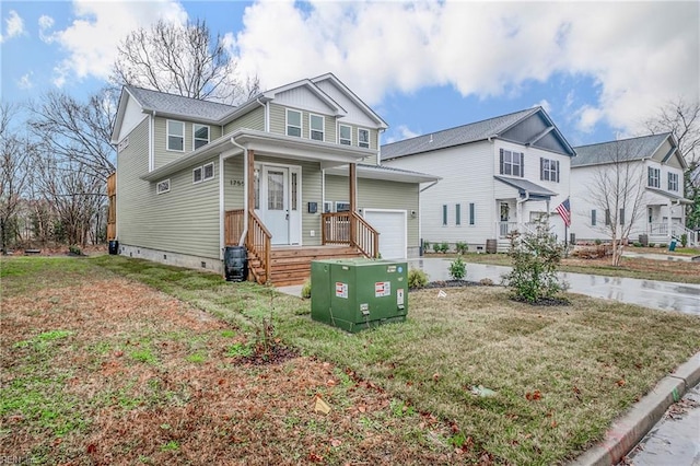 view of front of property featuring a front yard and a garage