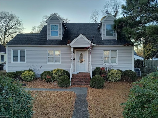 new england style home featuring central AC unit