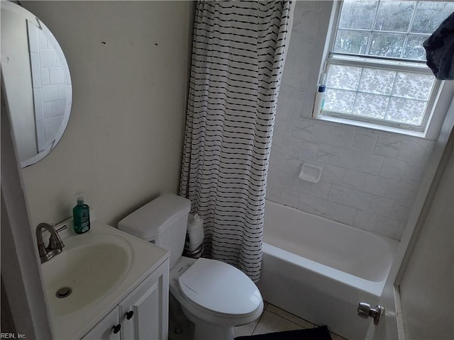 full bathroom featuring tile patterned floors, vanity, tiled shower / bath combo, and toilet