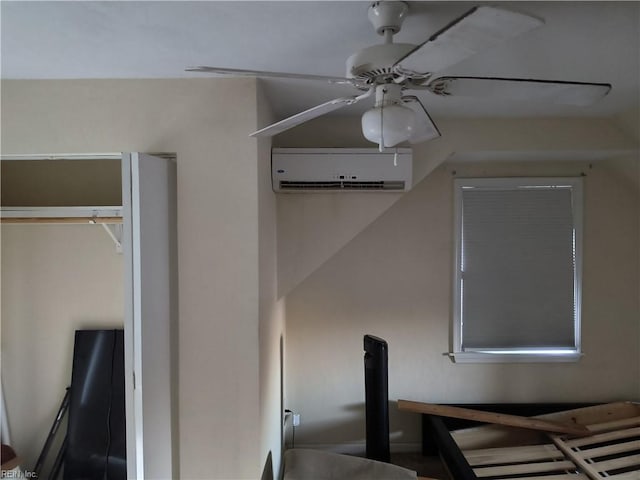 unfurnished bedroom featuring ceiling fan and a wall unit AC