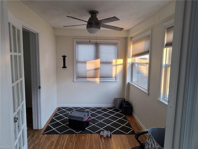 unfurnished sunroom with ceiling fan