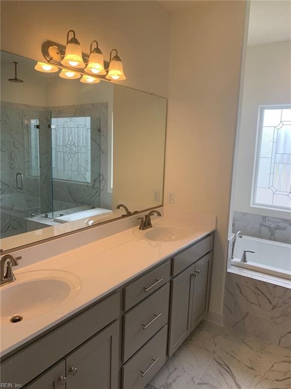 bathroom with vanity and independent shower and bath