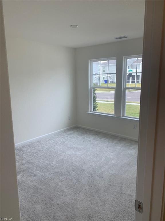 unfurnished room with light colored carpet