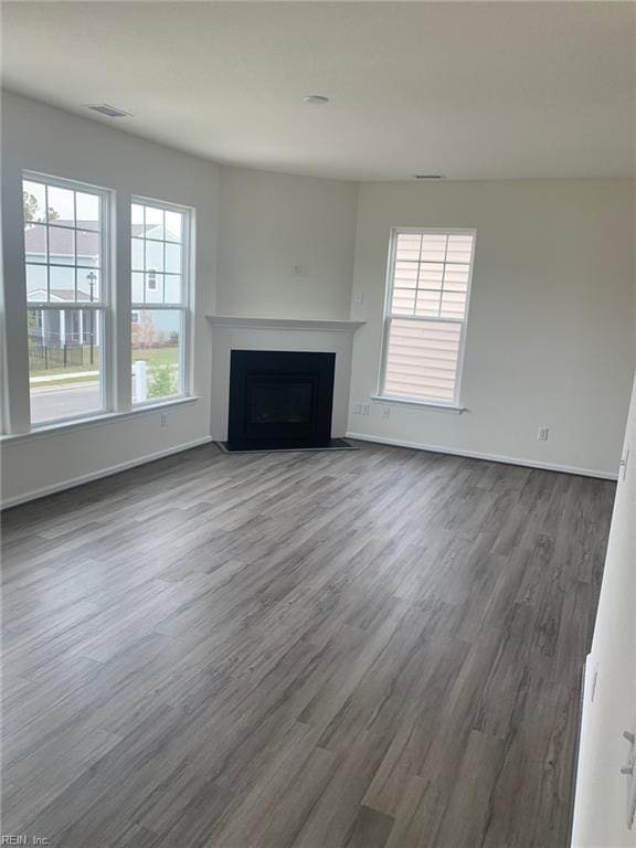 unfurnished living room featuring hardwood / wood-style flooring