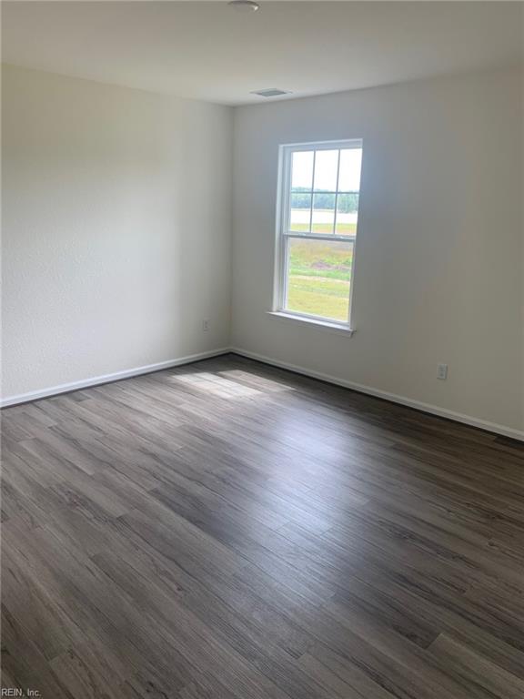 spare room with dark hardwood / wood-style flooring