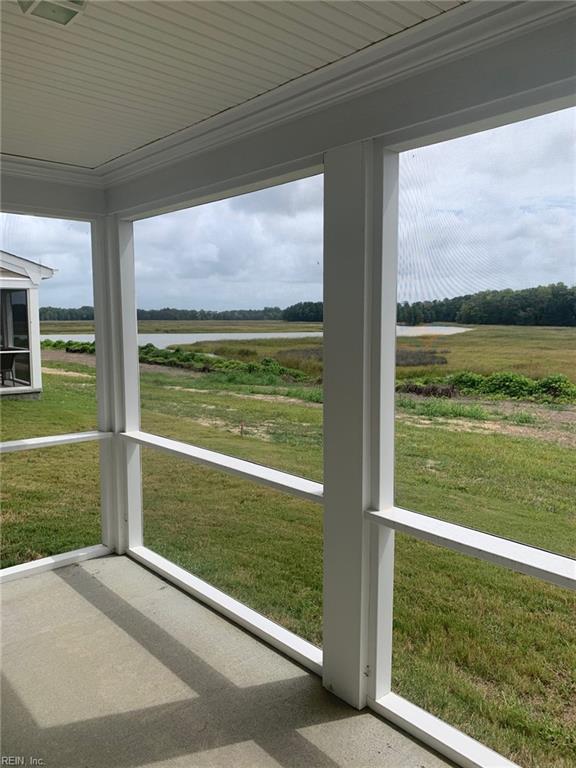 unfurnished sunroom featuring a rural view