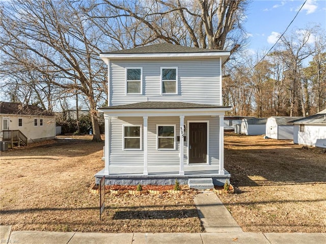 view of front property with a storage shed