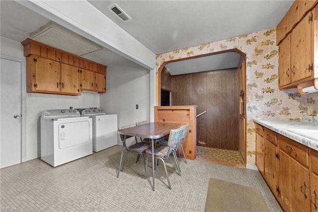 washroom with cabinets and washing machine and dryer