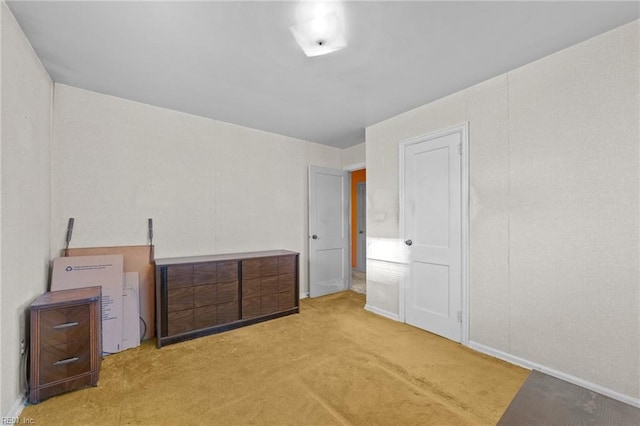 unfurnished bedroom with light colored carpet