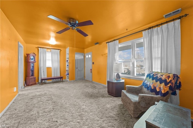 sitting room with ceiling fan and carpet floors