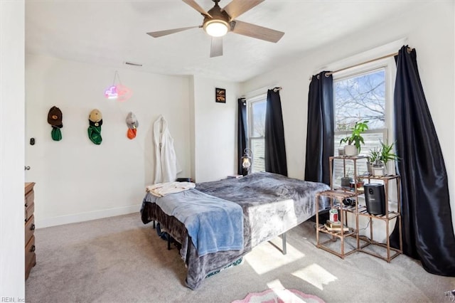 bedroom featuring ceiling fan and light carpet