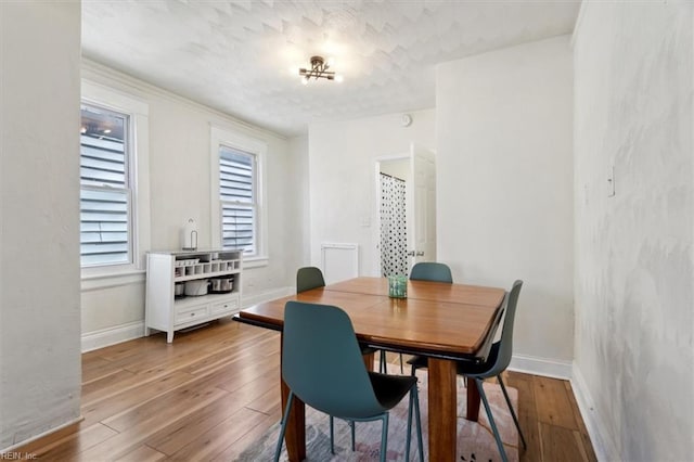 dining area with hardwood / wood-style flooring and a healthy amount of sunlight