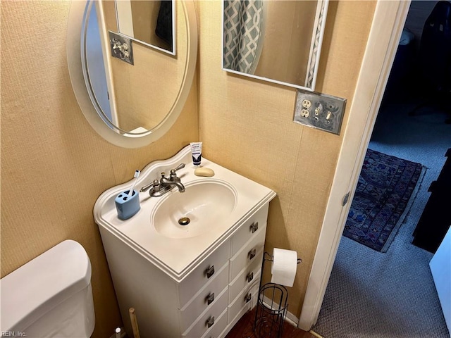 bathroom with toilet and vanity