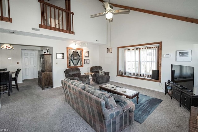 living room with carpet flooring, ceiling fan, beamed ceiling, and high vaulted ceiling