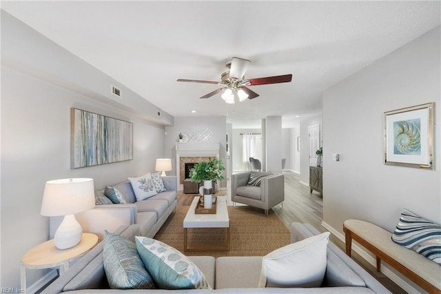 living room featuring hardwood / wood-style flooring and ceiling fan