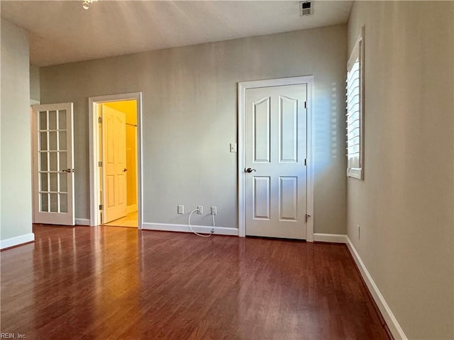 unfurnished bedroom featuring dark wood-type flooring