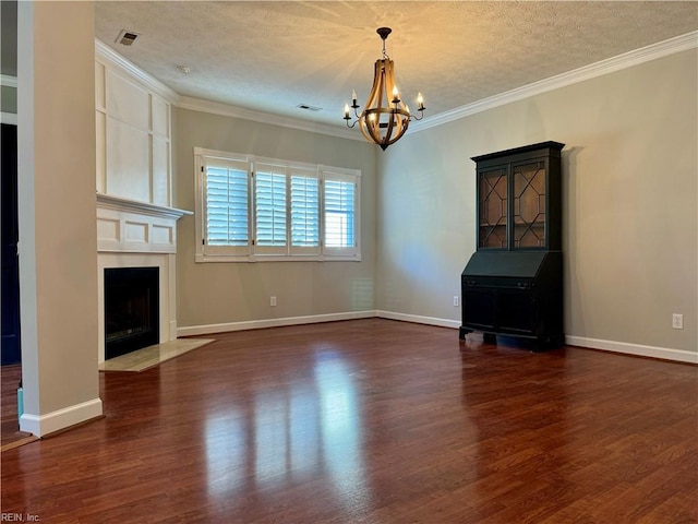 unfurnished living room with a notable chandelier, crown molding, a textured ceiling, and dark wood-type flooring