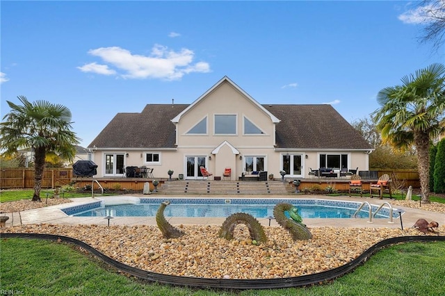 view of pool featuring french doors and a deck