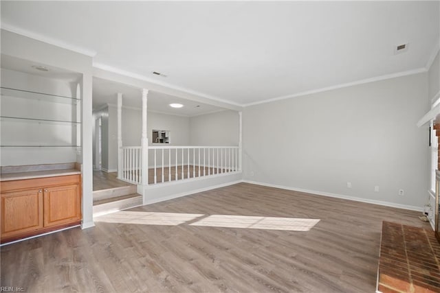 empty room featuring hardwood / wood-style flooring and ornamental molding