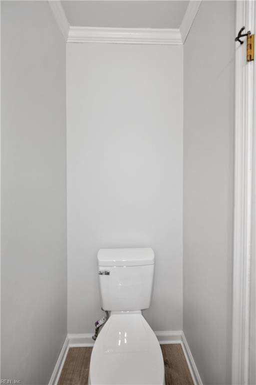 bathroom featuring hardwood / wood-style floors, toilet, and crown molding