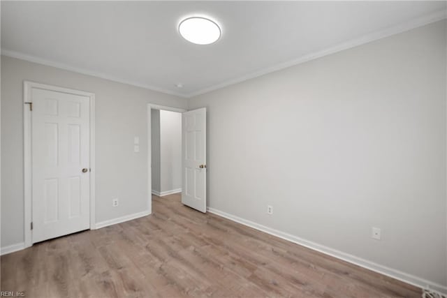 unfurnished bedroom featuring light wood-type flooring and ornamental molding