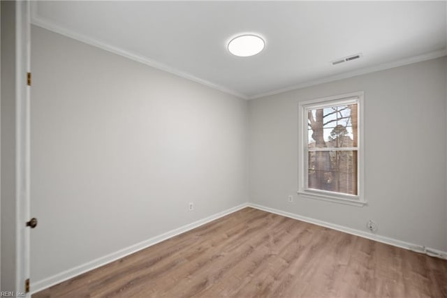 unfurnished room featuring crown molding and light hardwood / wood-style flooring