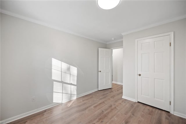 unfurnished bedroom with crown molding and light hardwood / wood-style flooring