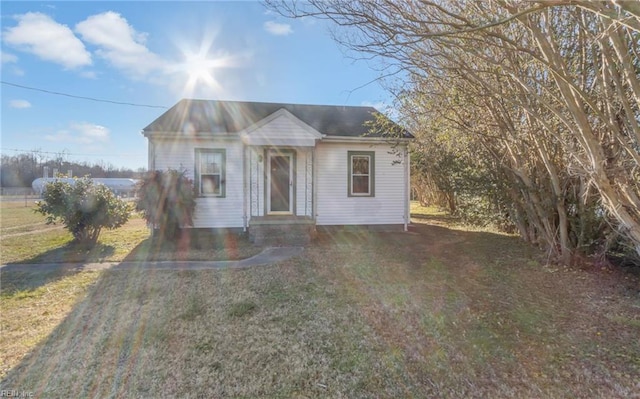 bungalow-style house with a front lawn