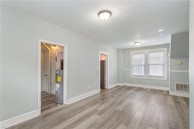 interior space featuring hardwood / wood-style floors and water heater