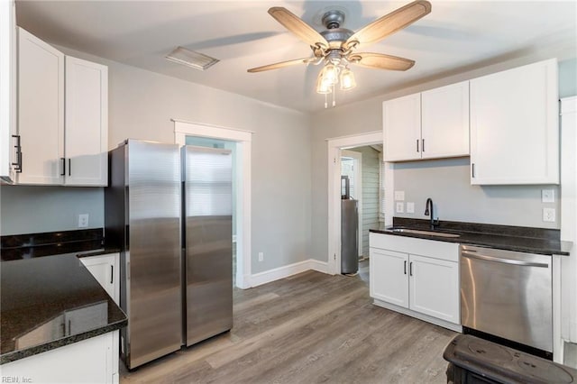 kitchen featuring white cabinets, appliances with stainless steel finishes, ceiling fan, and sink