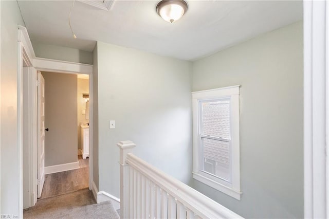 hallway featuring light colored carpet