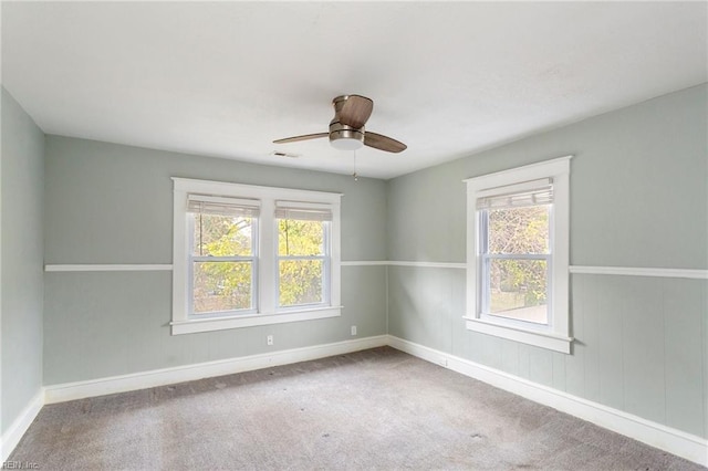 carpeted empty room featuring ceiling fan