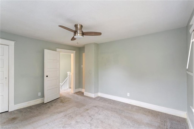 unfurnished bedroom featuring light colored carpet and ceiling fan