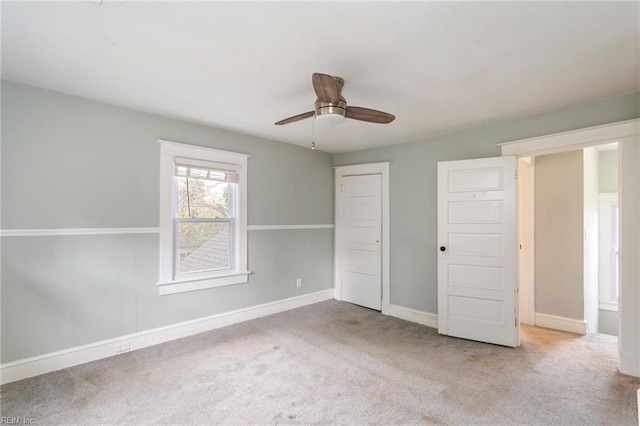 unfurnished bedroom featuring light colored carpet and ceiling fan