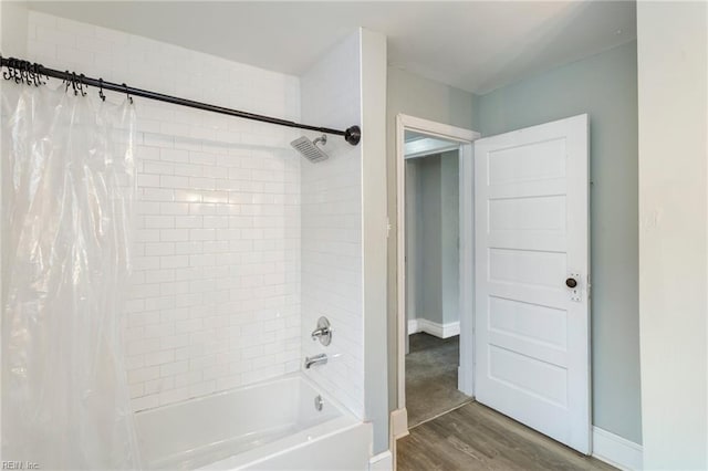 bathroom featuring hardwood / wood-style floors and shower / bath combo