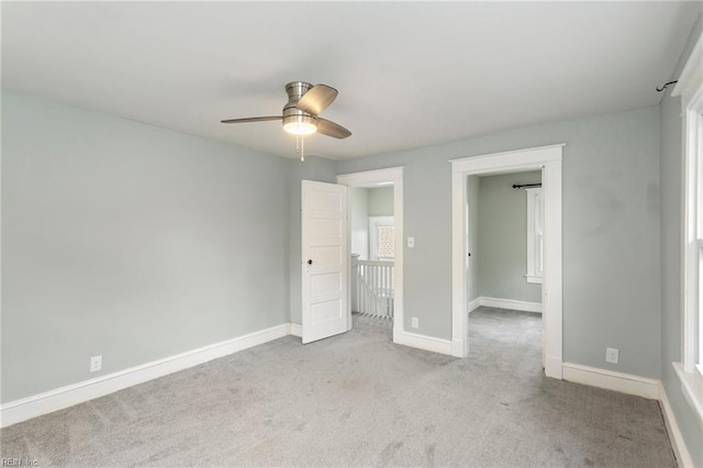 unfurnished bedroom with light carpet and ceiling fan