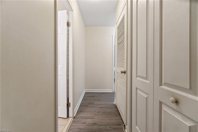 corridor with hardwood / wood-style floors