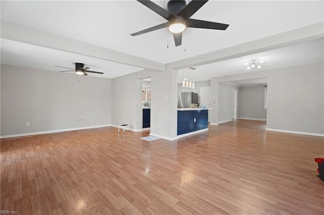 unfurnished living room featuring ceiling fan and light hardwood / wood-style floors