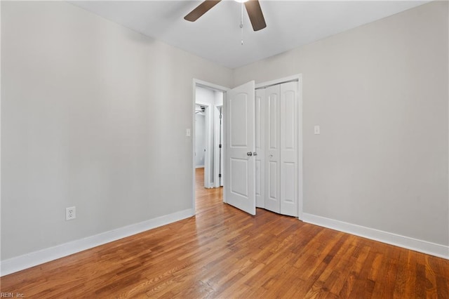 unfurnished bedroom with ceiling fan, a closet, and light hardwood / wood-style flooring