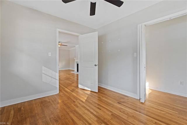 spare room featuring ceiling fan and light hardwood / wood-style floors