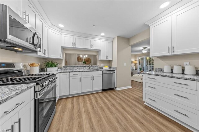 kitchen featuring sink, white cabinetry, and stainless steel appliances