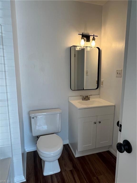 bathroom featuring hardwood / wood-style flooring, vanity, and toilet