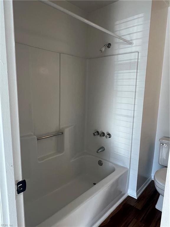 bathroom with  shower combination, toilet, and wood-type flooring