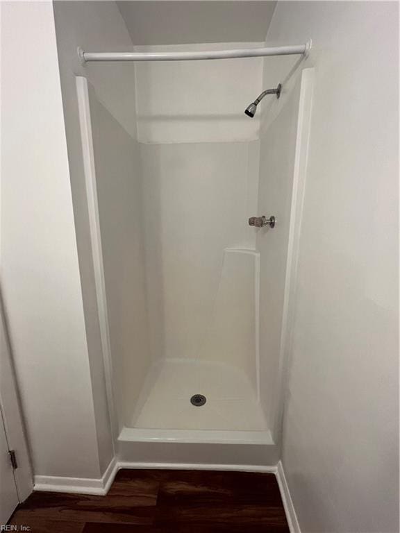 bathroom with hardwood / wood-style floors and walk in shower